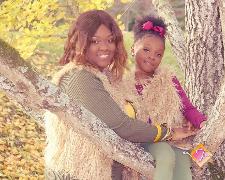 A mother and daughter among autumn trees